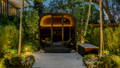 A warm illuminated outdoor retreat nestled within lush garden lighting, blending architecture and landscape seamlessly by Havit Lighting.