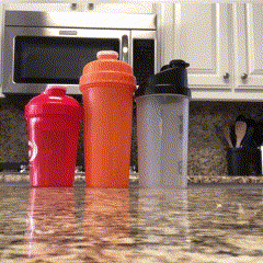 a .gif image showing standard shaker bottles on a counter. The High-Quality Insualted Ice Shaker slides across the counter and knocks the standards bottles off. 