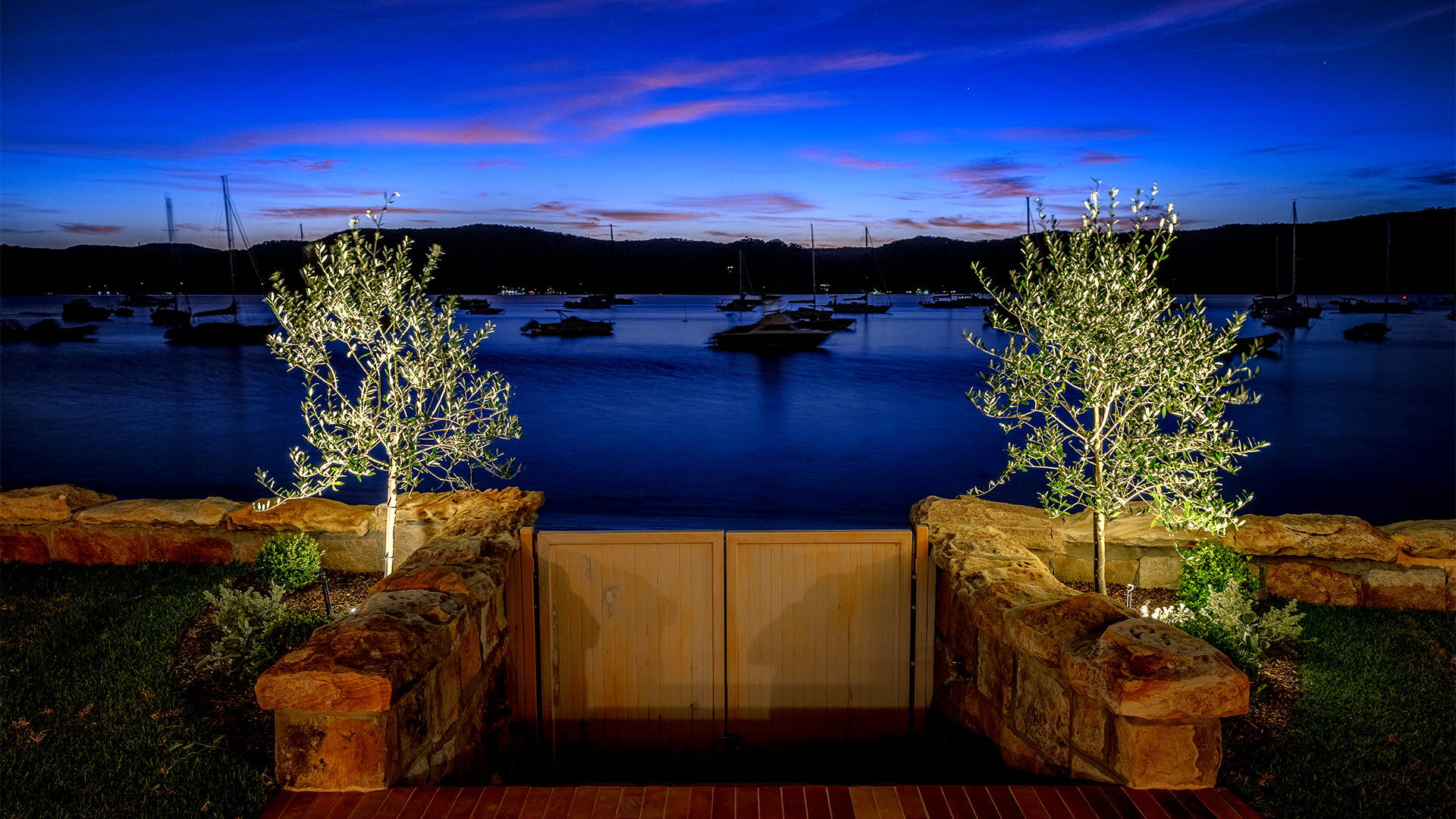 Havit Lighting - Outdoor Lighting by Havit  - Garden Lighting by Havit - Backyard facing the jetty at Palm Beach, with two small trees lit up by inground lights by havit.