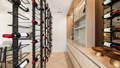 Havit LED strip and downlights illuminating a cellar room with floor-to-ceiling wine racks, timber cabinetry and herringbone floors