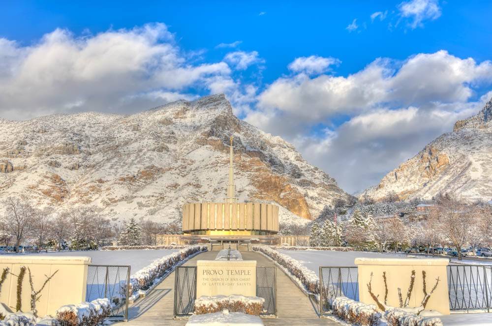 Provo Temple beneath a blue sky surrounded by snow