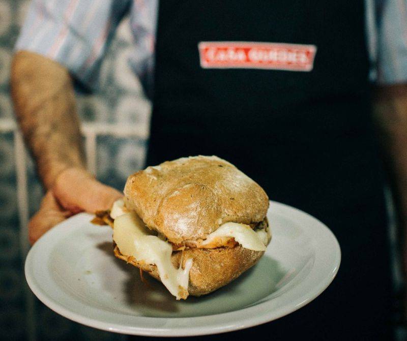 Our team picks Casa Guedes' sandes de pernil with queijo da serra as a must-try typical fast food in Porto.