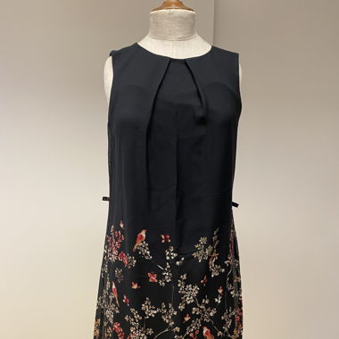 Black dress with bird pattern at the hem