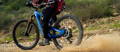 Electric mountain bike rider skidding on trail