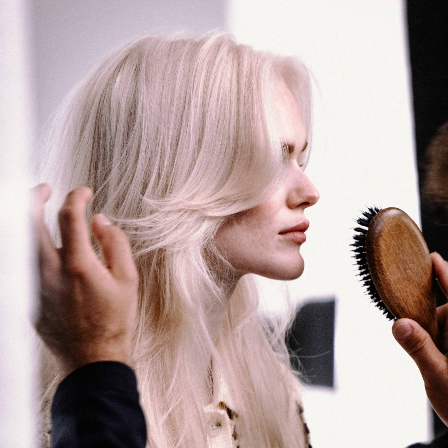 Blonde woman getting her hair cut by a Davines stylist