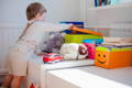 Little boy opening a storage box. 