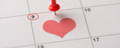 Calendar marking proposal date with a heart and pin