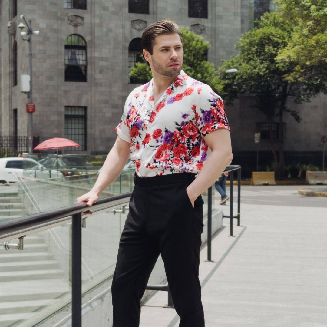 model standing outside wearing black pants and a short sleeve white floral silk shirt from 1000 kingdoms