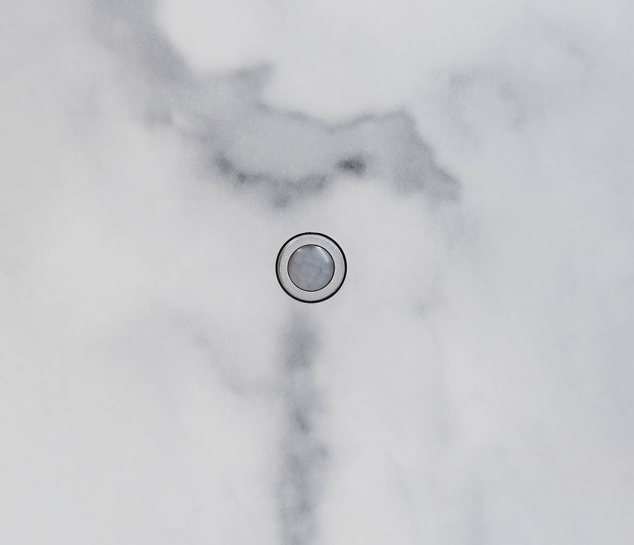 Faradite matt white TAP-1 mounted on a kitchen wall used with Loxone