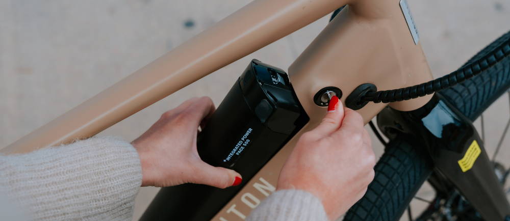 Close up of unlocking battery on Aventon Pace electric bike