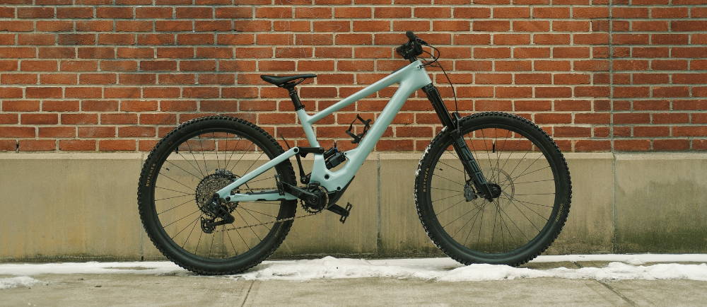 A Specialized e-MTB against a brick wall