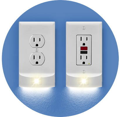 Two MotionLight hallway lighting outlet covers on a blue wall