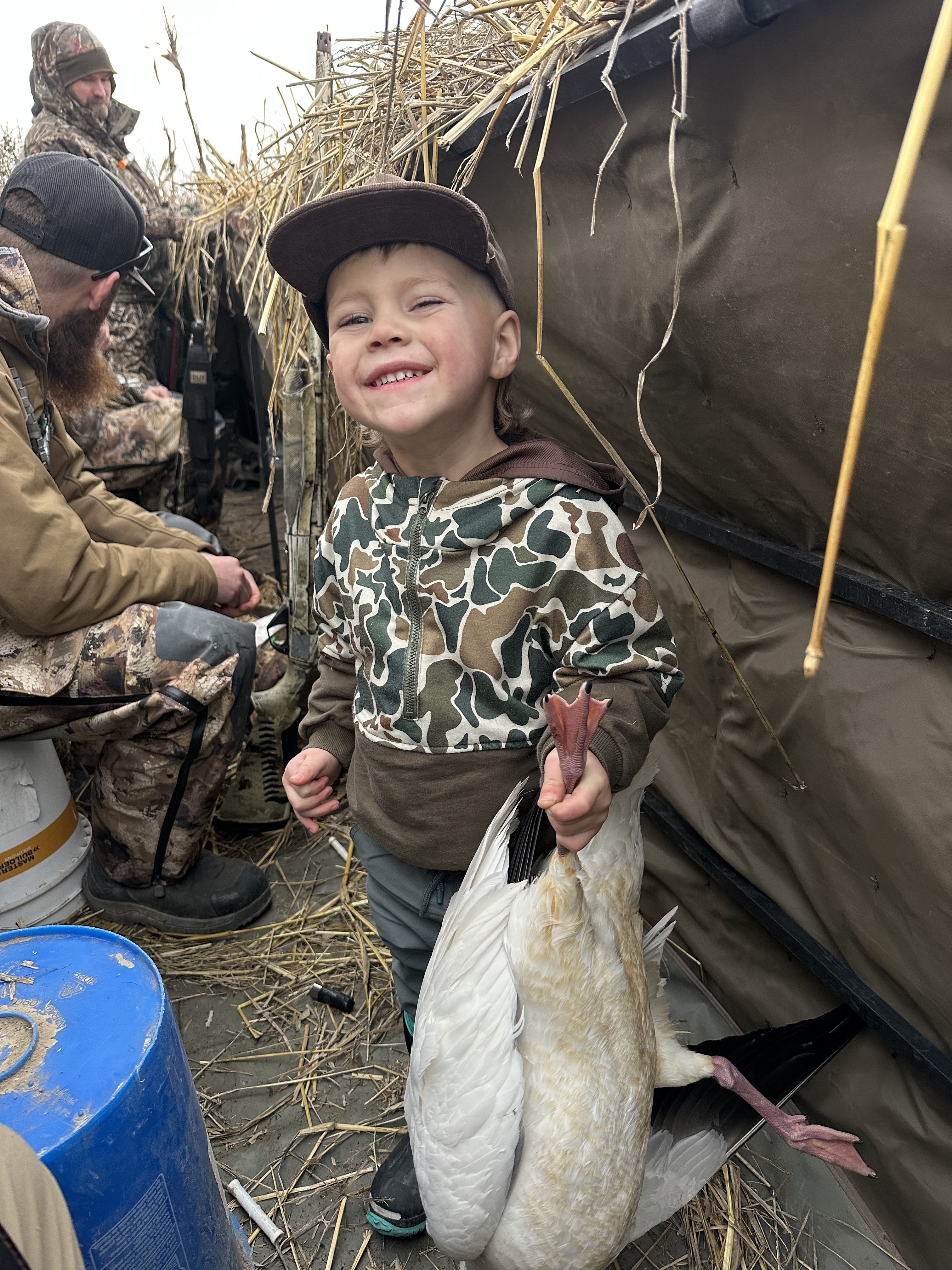 Young hunter holding a snow goose