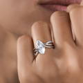 Woman wearing a very stylish engagement ring posing in a close-up picture