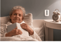 Elderly woman on bed next to a FlexFob attached to wall next to bed for easy access.