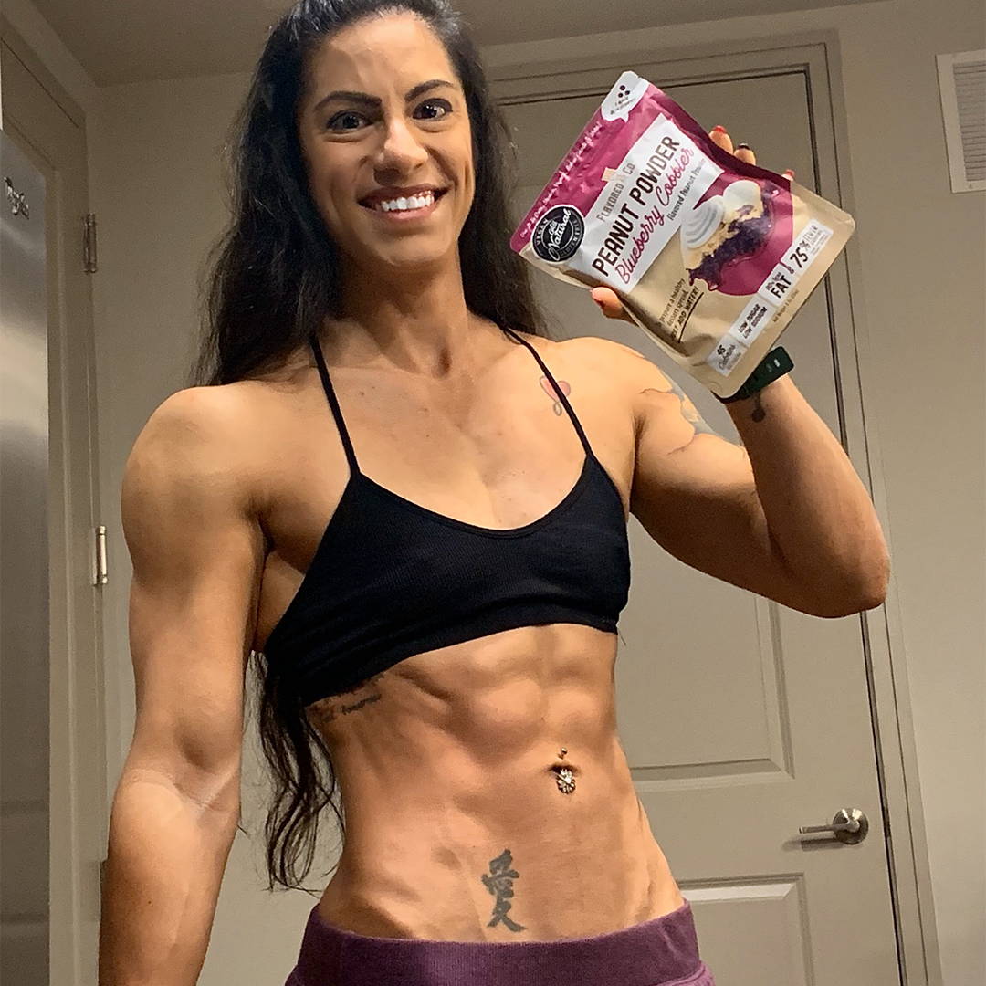 Woman using flavored pb co flavored peanut powder as an healthy snack for working out