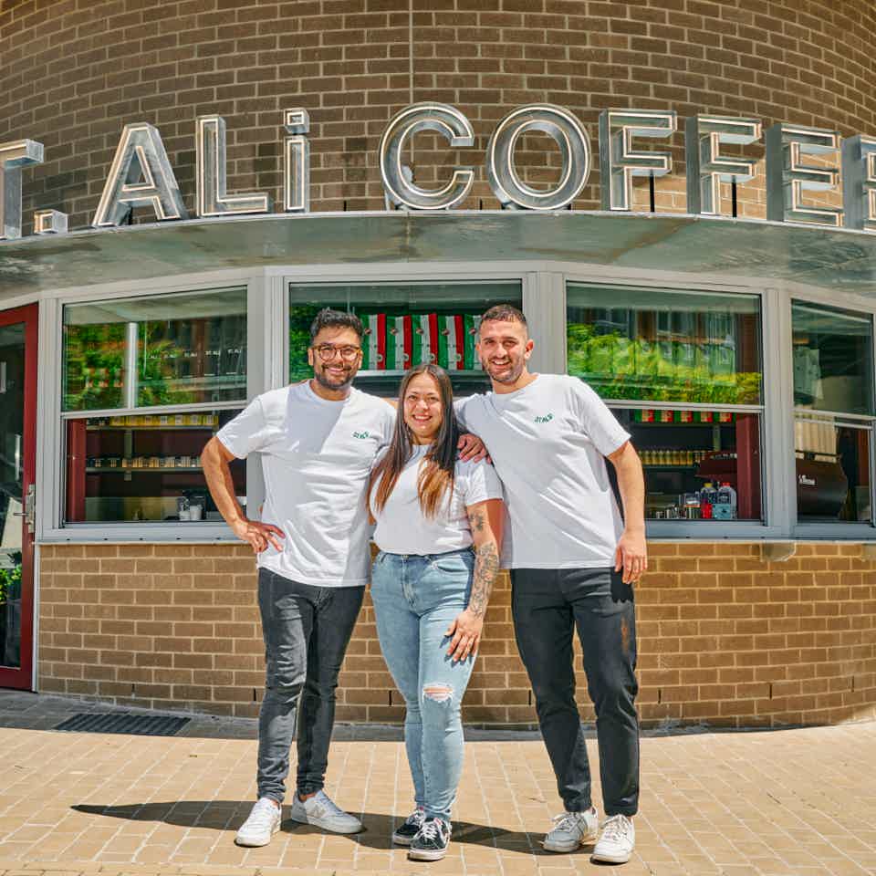 Three staff smiling outside of ST. ALi cafe