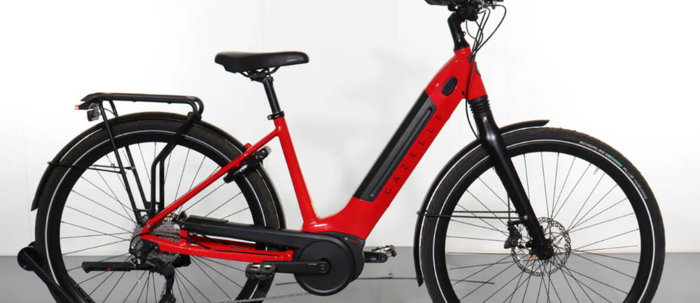 a red Gazelle Ultimate T10 electric city bike