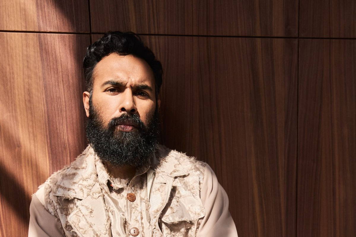Image may contain: Himesh Patel, Person, Sitting, Face, Head, Adult, Black Hair, Hair, and Beard