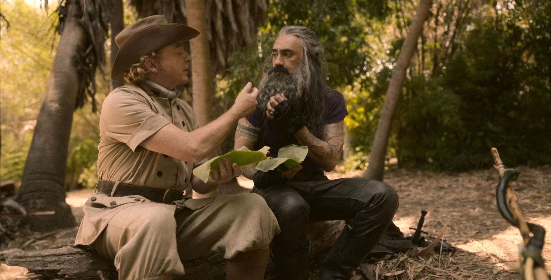 Ed and Stede sharing a close moment. They are sitting down together and are sharing a meal.