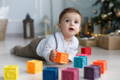 Cute baby boy playing with silicone blocks. 