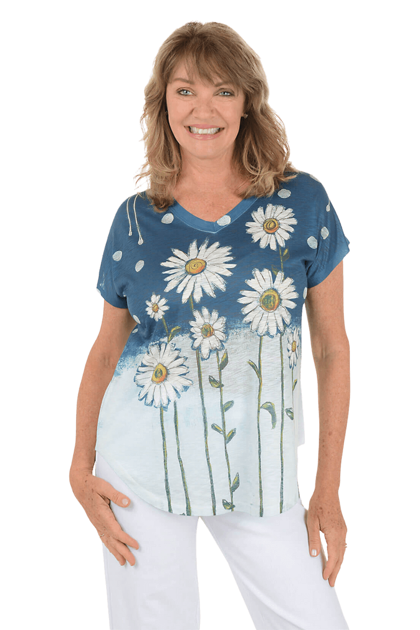 A woman wearing a floral printed top and white pants