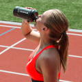 Track and field athlete drinking Ultimate Hydration