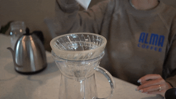 Woman putting filter in V60
