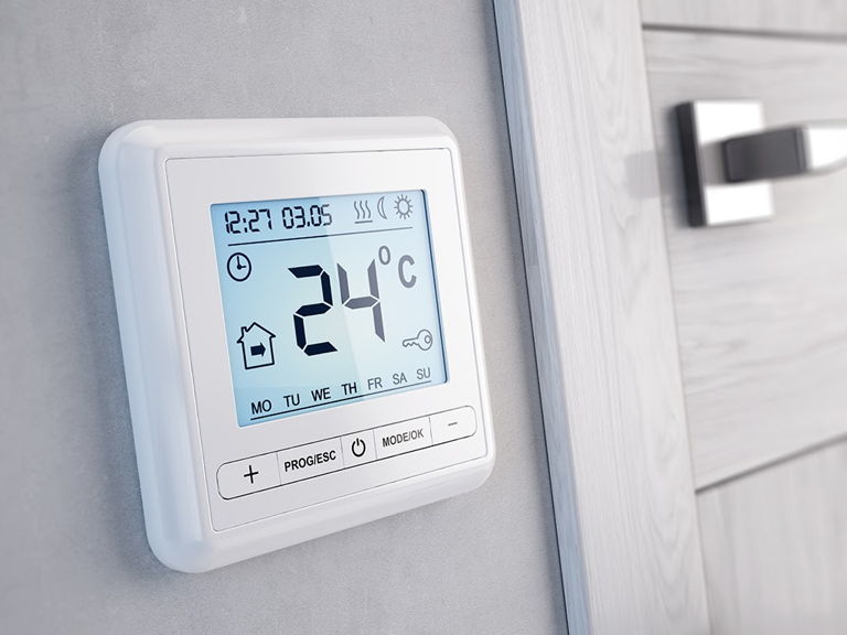 A wall-mounted digital programmable thermostat