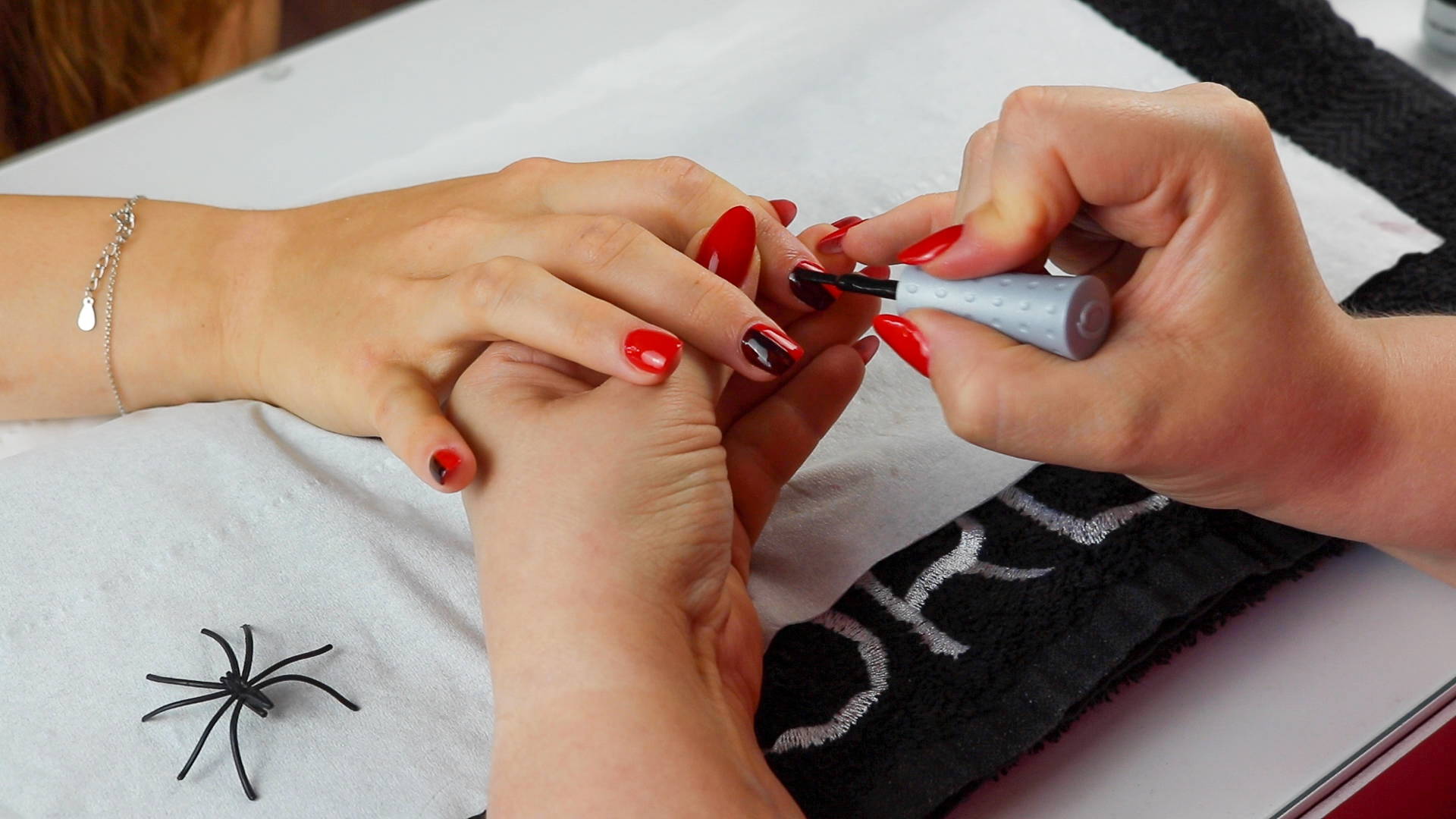 Nail stripe being painted onto nails using ORLY Liquid Vinyl to create Harley Quinn nails