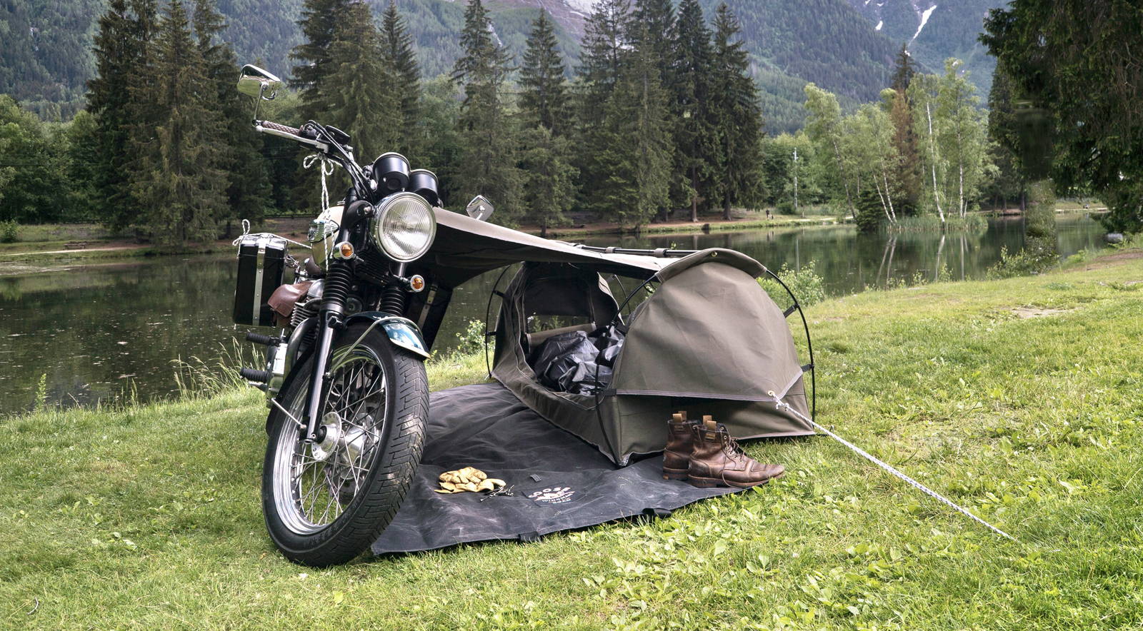 Wingman of the Road motorcycle and camping system beside a lake
