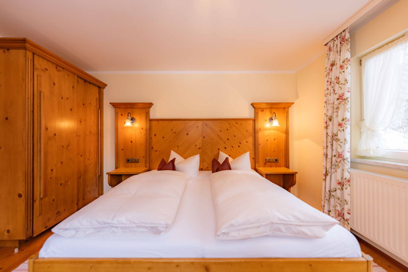 Schlafzimmer mit Doppelbett im Apartment von Hugo & Pepi in Mittelberg im Kleinwalsertal.