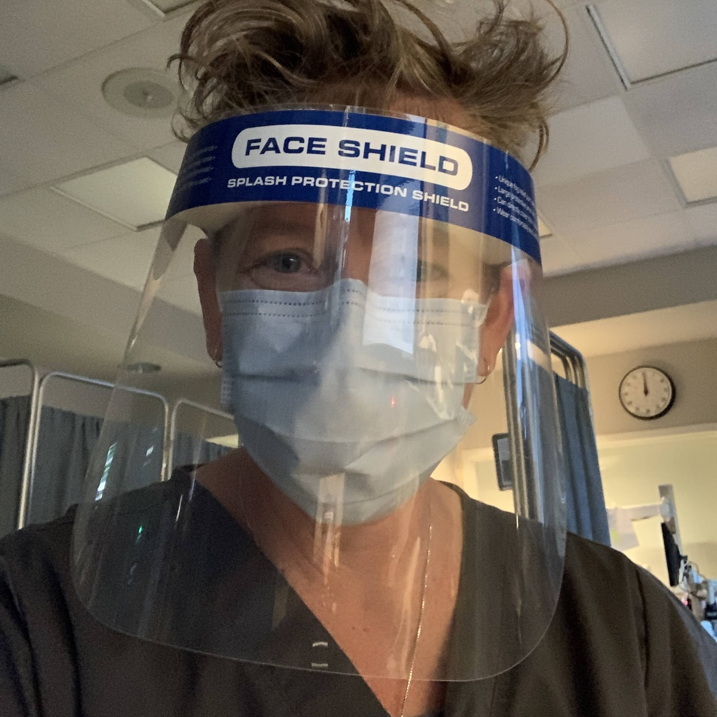 NICU RN neonatal nurse Trish Ringley in face shield and mask to protect preemies from Covid-19 in the NICU