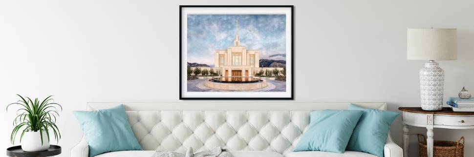 Framed Ogden Temple photo on the wall above a whitei sofa. 