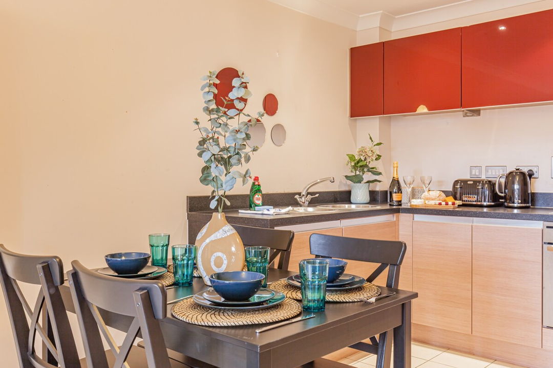 small corner kitchen with dining table for 4