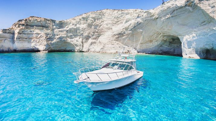 The stunning Sarakiniko Beach on Milos Island Greece is famous for its otherworldly, moon-like landscape, characterized by its white volcanic rock formations and turquoise waters, making it a popular destination for tourists and photographers alike