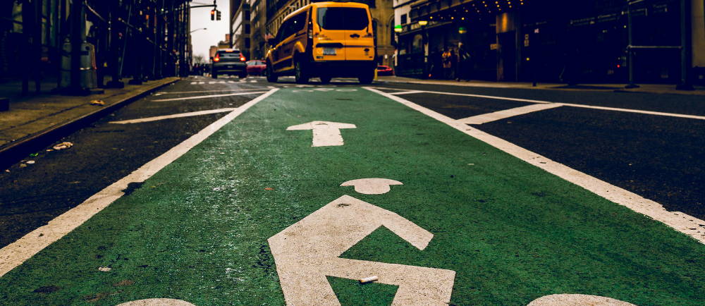New York City bike lane and yellow taxi