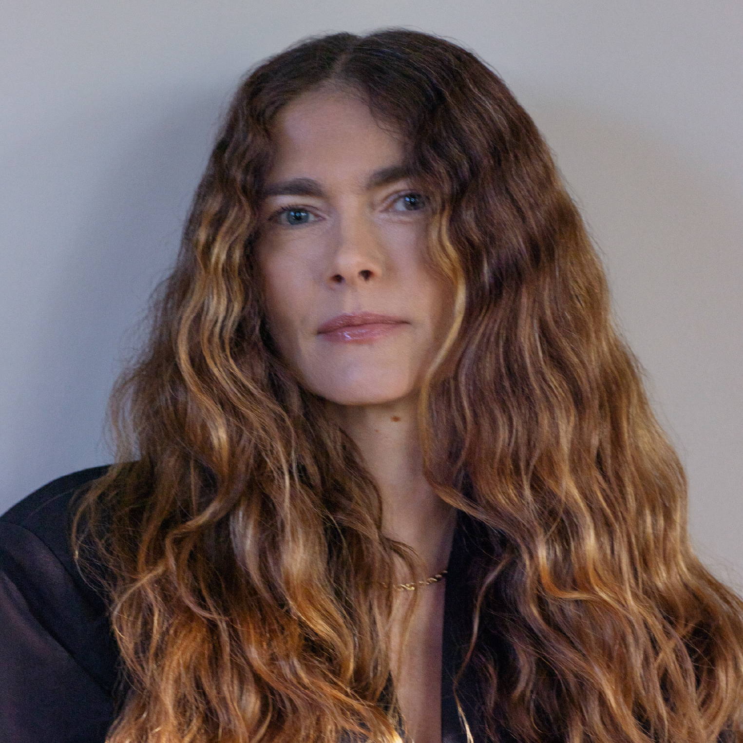 Davines hair model with brown wavy hair and green eyes