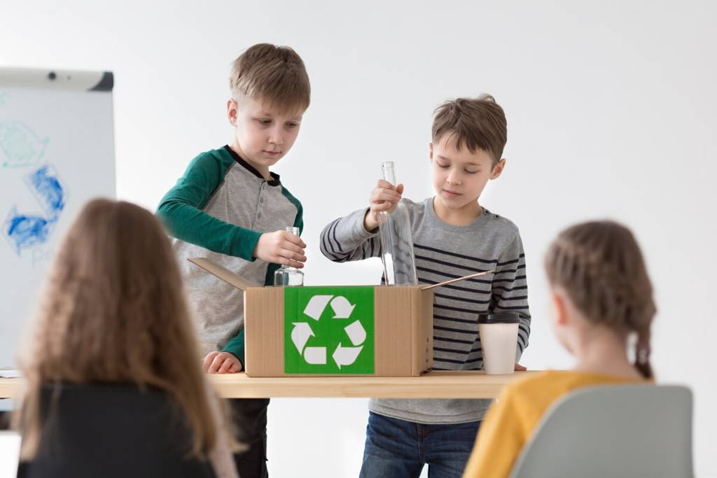Two boys having a presentation in their class on how to recycle.