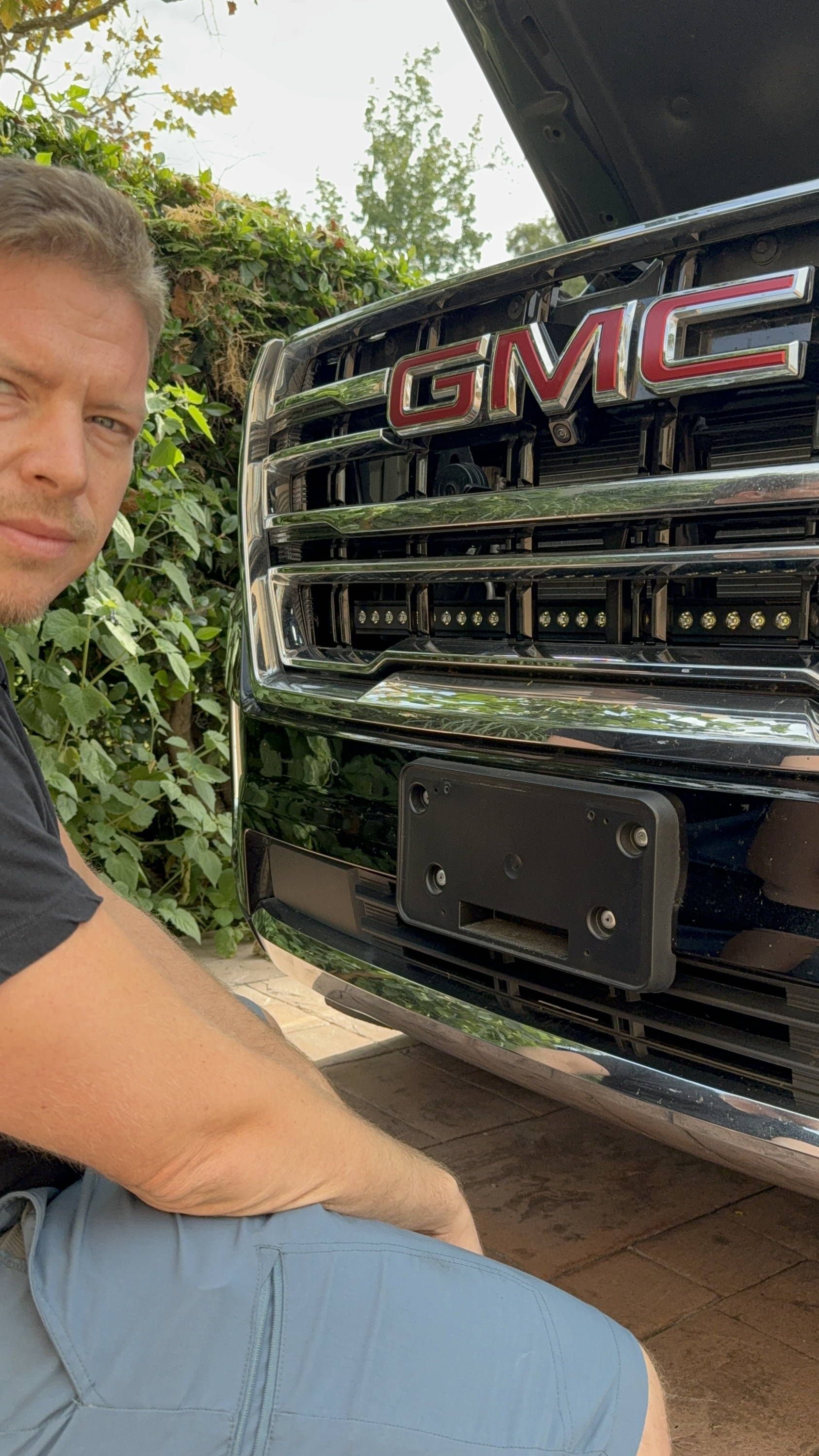 mike owner of m&R automotive designs brackets to fit 40in off roading light bars behind the grille on the 2023 gmc yukon 