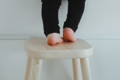 Kid standing on a step stool.