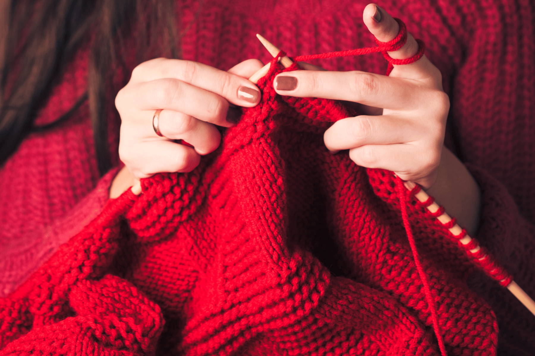 woman knitting a red sweater