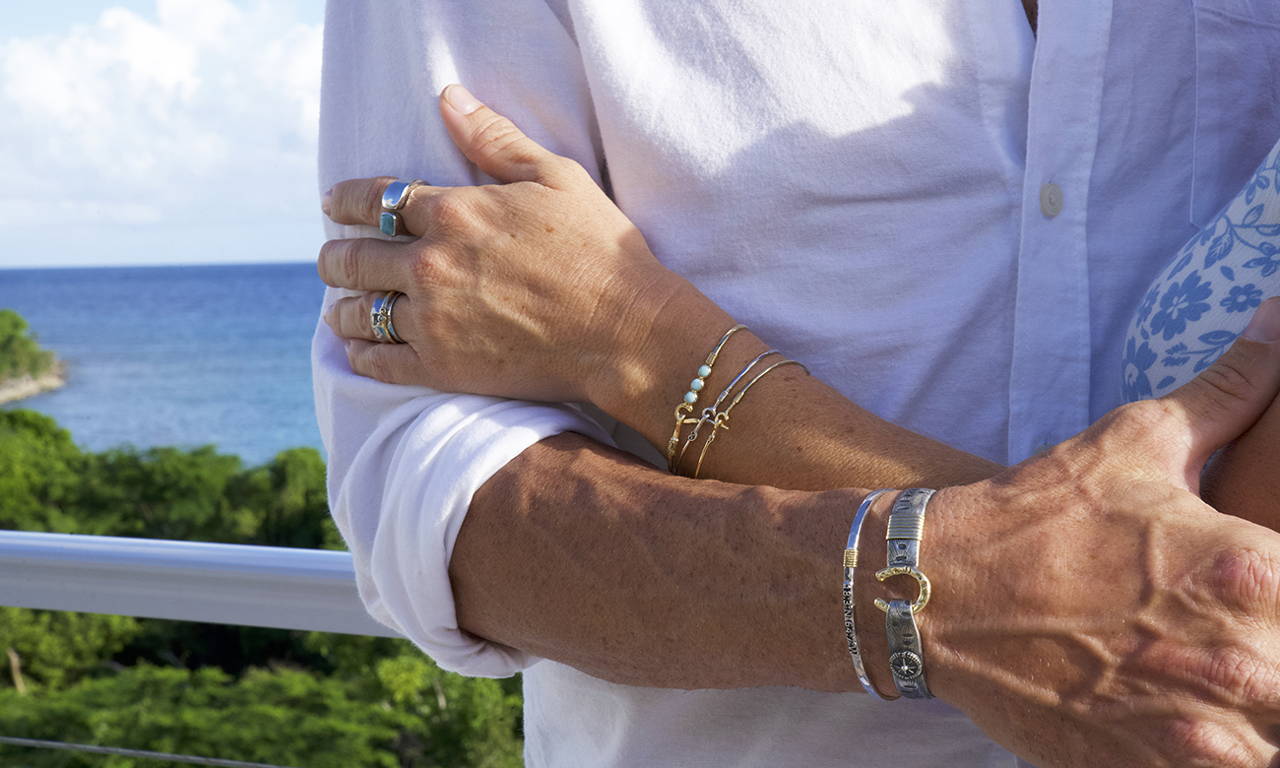 A man and woman both wearing Valentine's Day jewelry on their hands