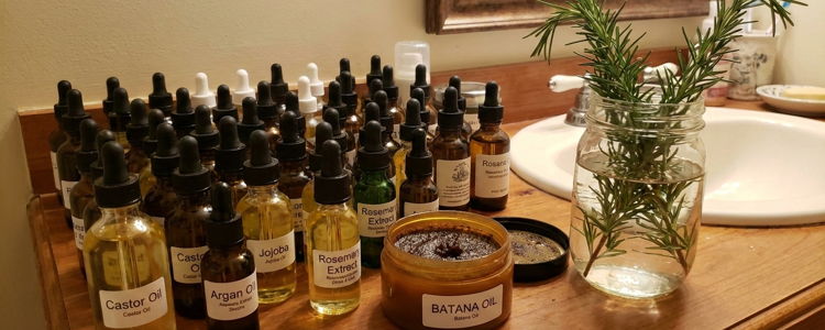 Botanical extracts in amber dropper bottles beside fresh rosemary