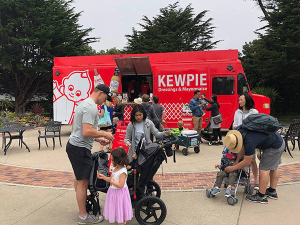 Families getting free food at the kewpie food truck