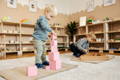 Children playing with wooden toys in an Montessori environment.