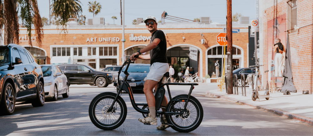 Male straddling a rad power e-bike in the street