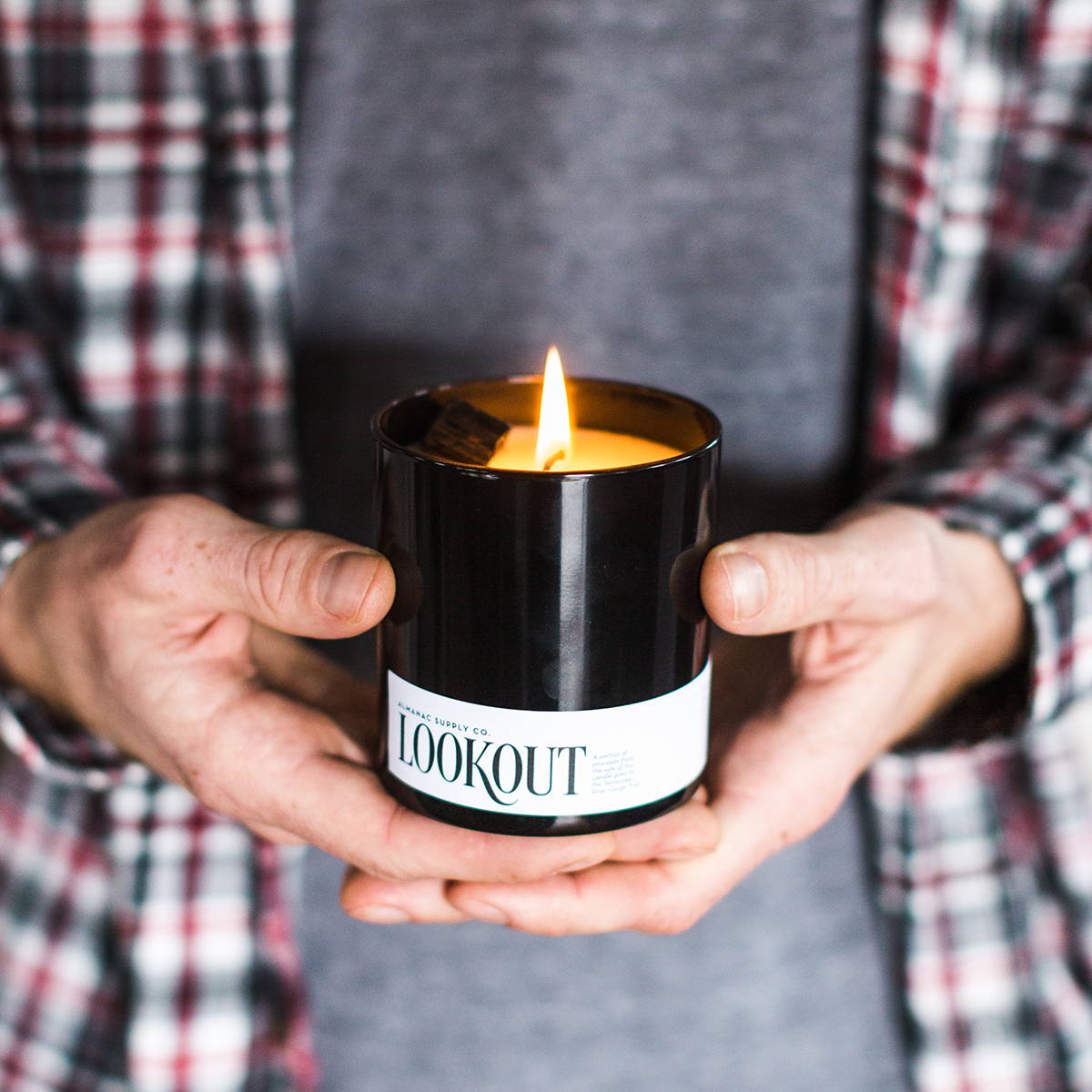 Hands holding a lit Lookout Candle, named after the Chattanooga mountain