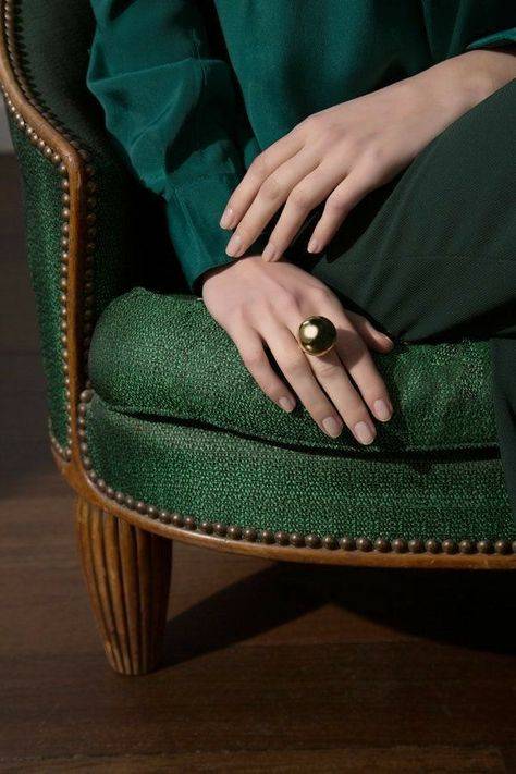 woman-dressed-in-green-sitting-on-a-green-couch