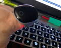 User wearing Wellue O2Ring while working at computer to track SpO2 levels